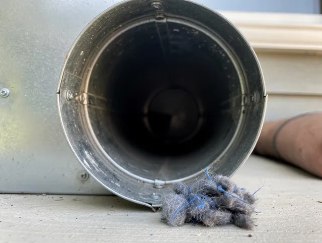 Lincoln Dryer Vent Cleaning technician using specialized equipment to clear severe dryer vent blockage in Lincoln